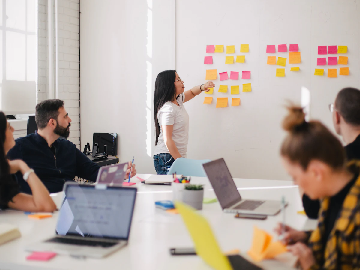 A team planning a campaign with sticky notes on a whiteboard